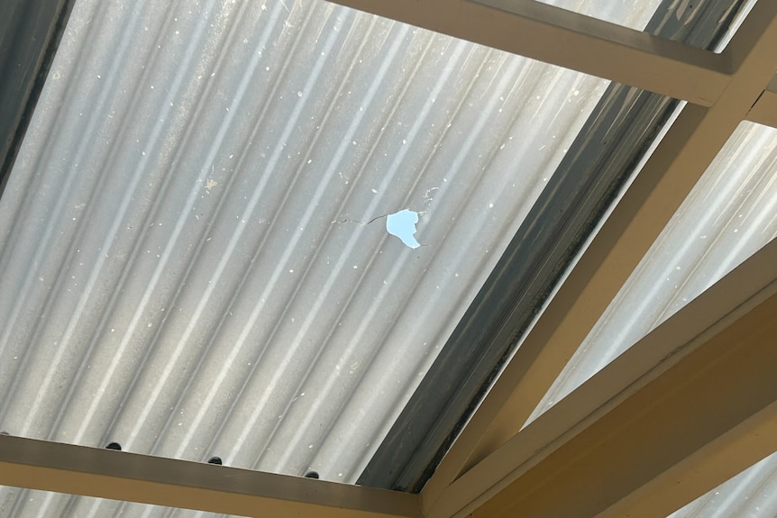 A hole in a corrugated plastic roof.