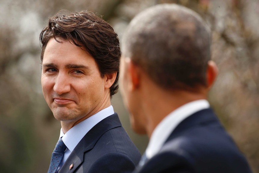 Justin Trudeau looks at Barack Obama smirking