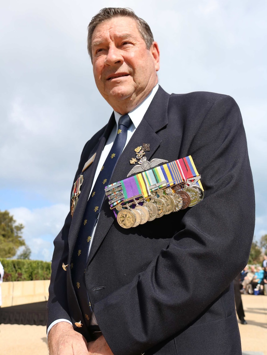 Former RAAF navigator Chris Rampant says long Tan stands with his medals worn on his chest.