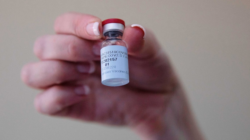 A healthcare worker holds a dose of the Johnson & Johnson vaccine against the COVID-19 coronavirus.