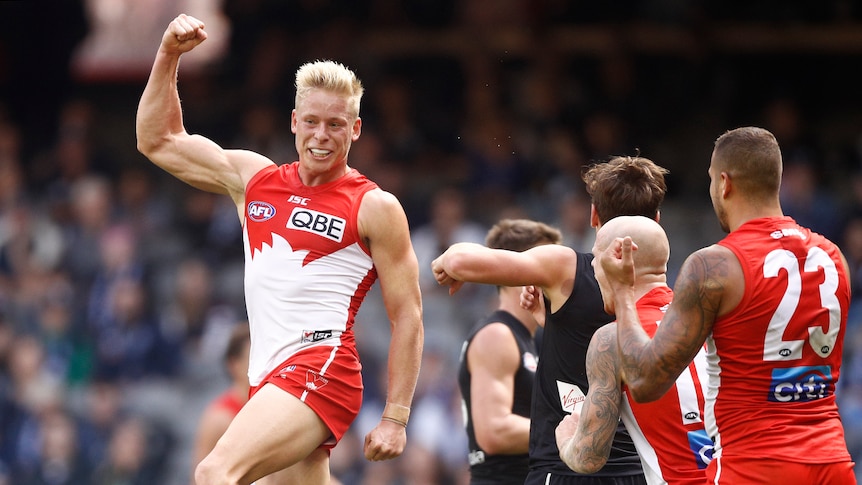 Isaac Heeney jumps in the air clenching his right fist