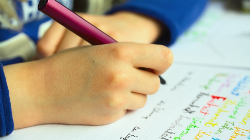 A child writing in a notebook