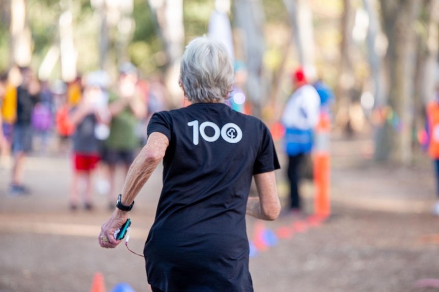 A shot of an older woman running from behind.