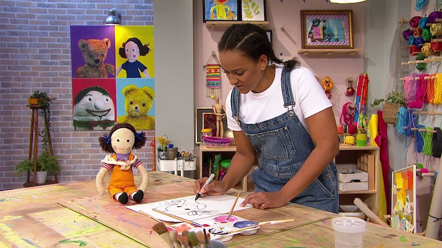 Toy Jemima sits on a desk as Zindzi draws Jemima's portrait