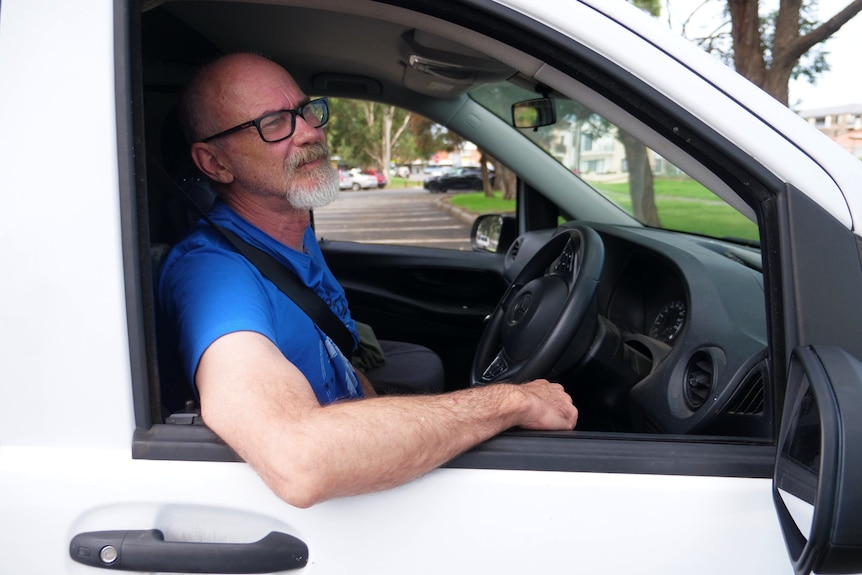 man in driver's seat of van.