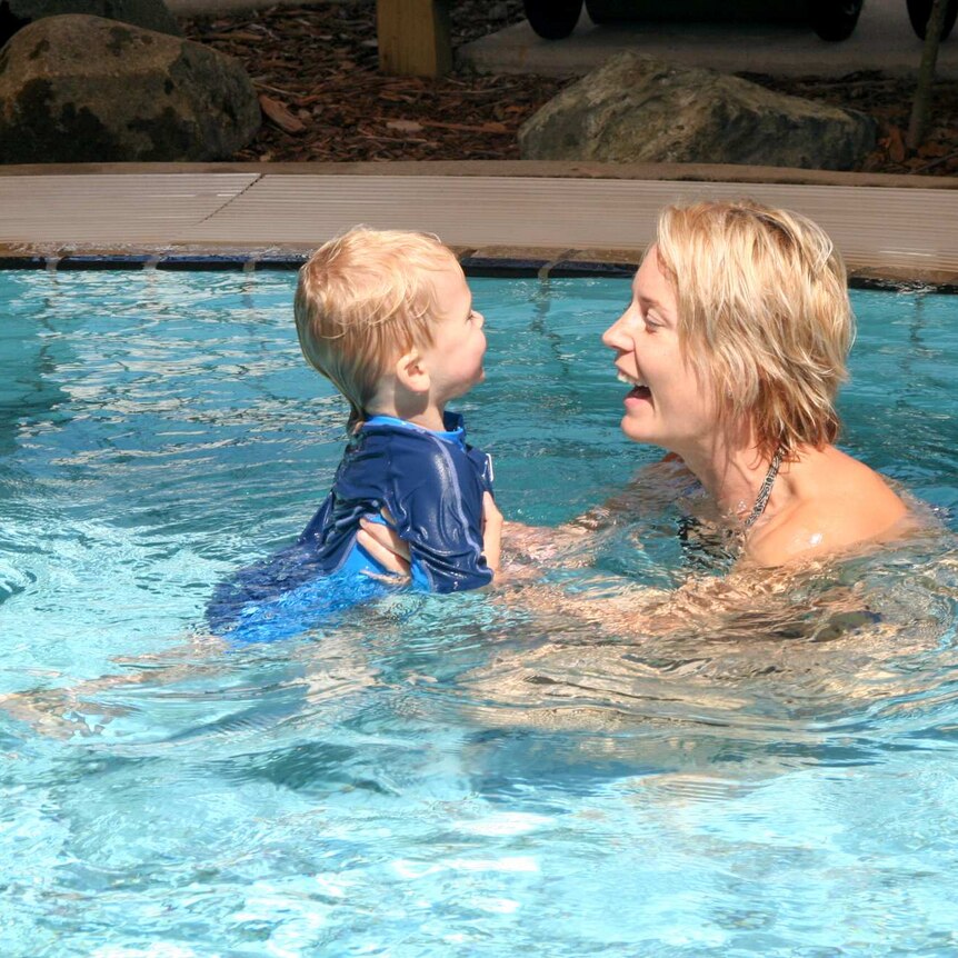 Mother and son swimming together