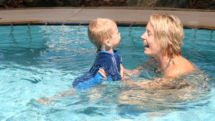 Mother and son swimming together