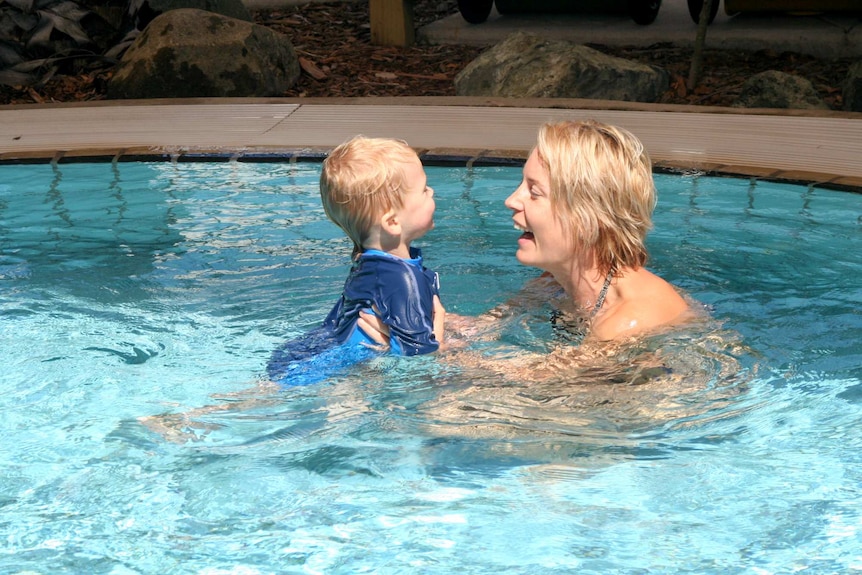 Mother and son swimming together