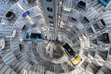 SUV vehicles are seen from the center of a high delivery tower.