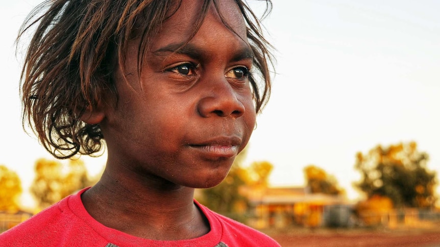 A young boy looks off into the distance.