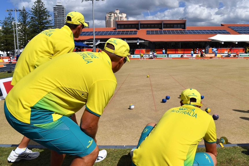 Australia's men's fours team watch a bowl from Aron Sheriff in the gold medal game against Scotland.