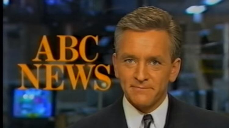 Ian Henderson sits at the ABC News desk.
