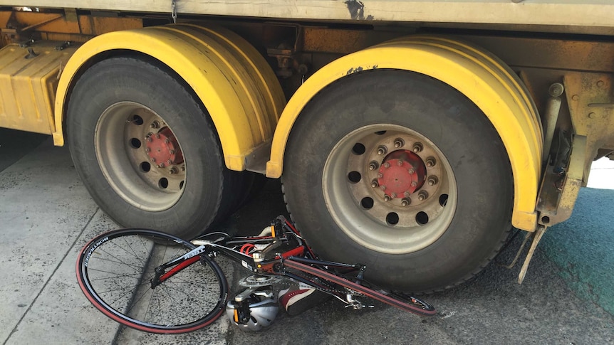 A bicycle is trapped under the back wheels of a truck after an accident in Hobart