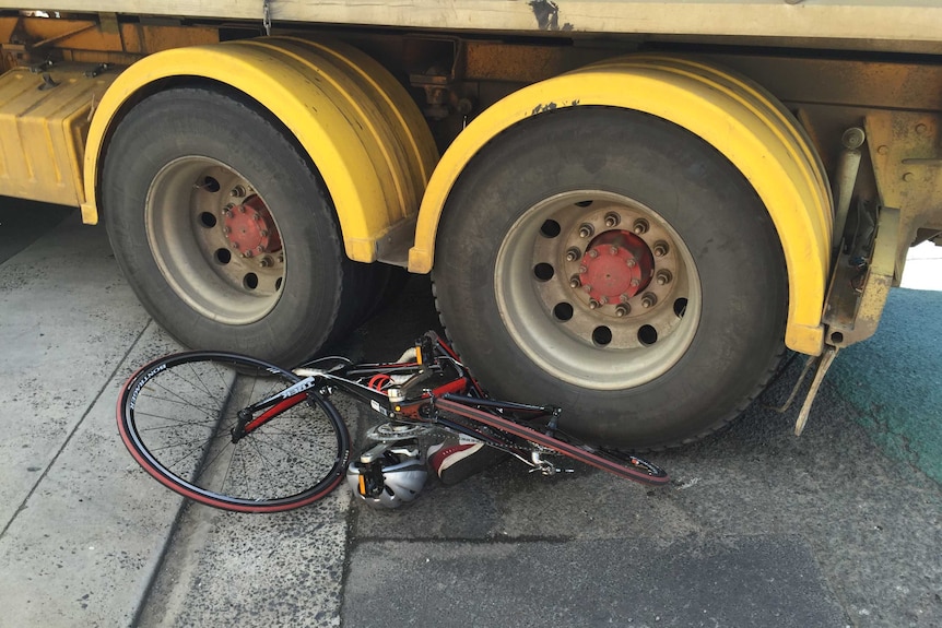 A bicycle is trapped under the back wheels of a truck after an accident in Hobart