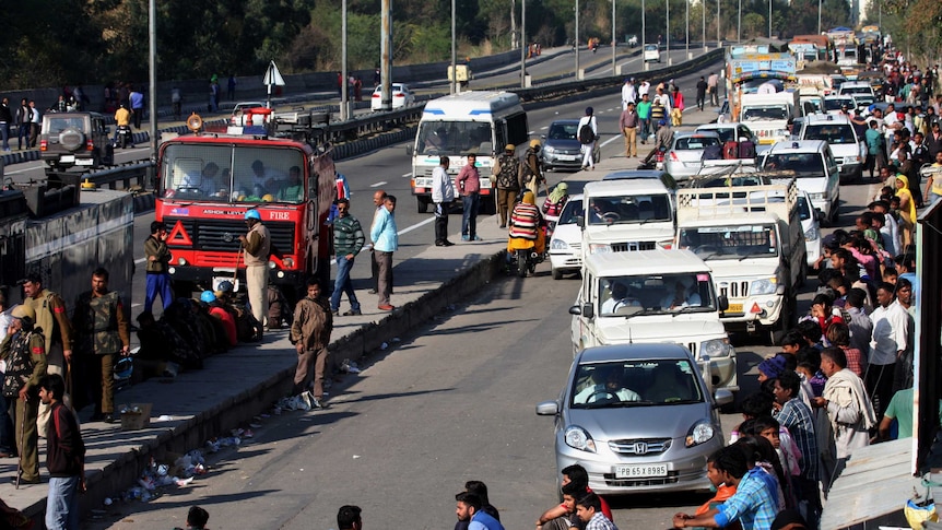 A line of traffic grows as members of India's Jat community block a major highway