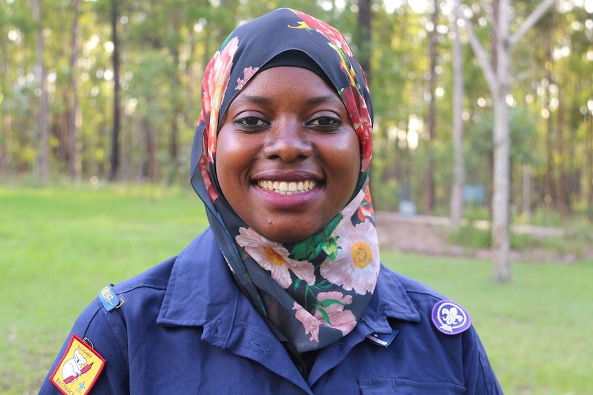 A woman in a Scout leader uniform wearing a head scarf
