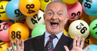Antony Green in front of lottery balls