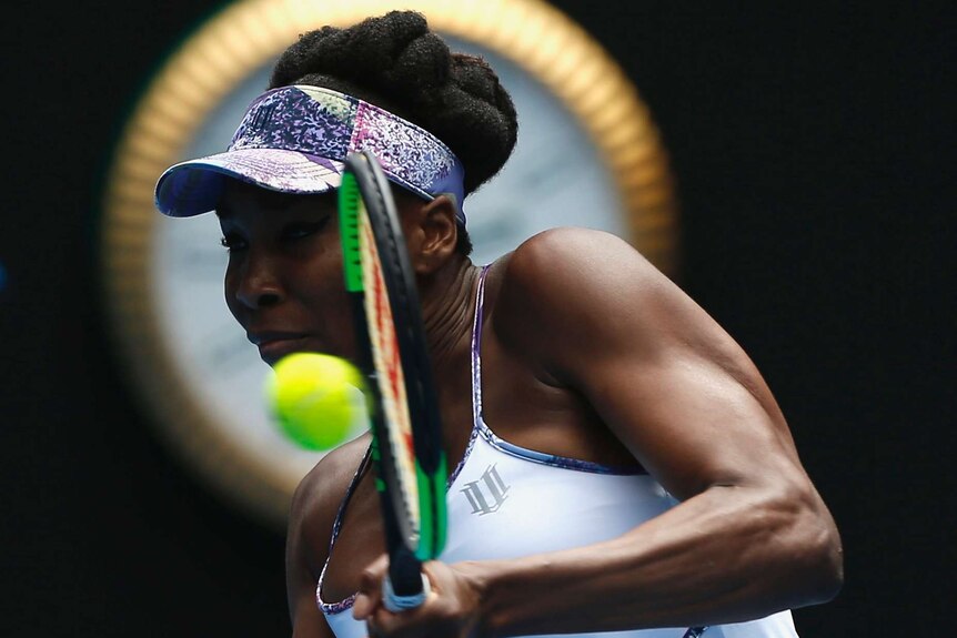 American Venus Williams hits a return against Coco Vandeweghe in their Australian Open semi-final.