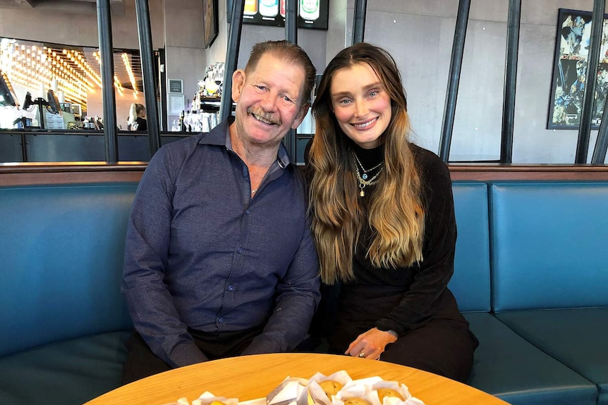 Heart transplant recipients Colin Manderson and Bec Craven, sit close together in a cafe in Brisbane on May 8, 2019
