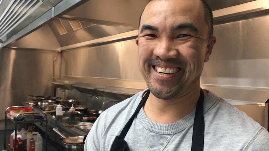 Alex Zhao is a chef in the family's Chinese restaurant in Sheffield, Tasmania. He's standing in the kitchen of the restaurant.