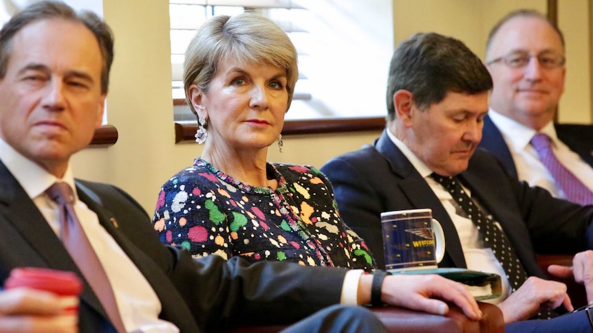 Julie Bishop looking annoyed as she sits in a coalition party room meeting