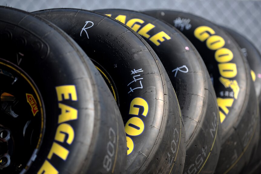 A group of racing tyres lie on the ground during practice ahead of a race.