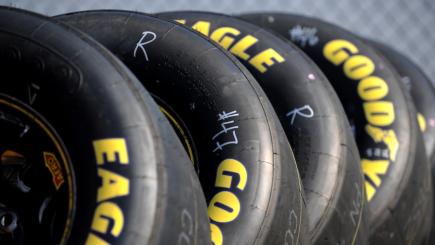 A group of racing tyres lie on the ground during practice ahead of a race.
