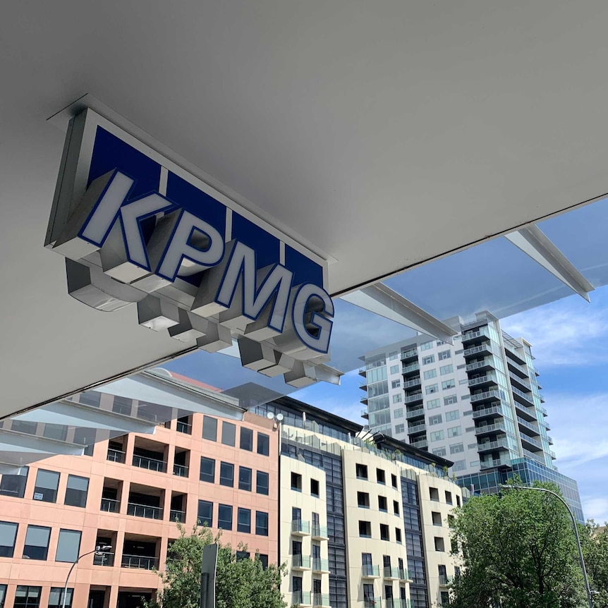 A sign saying KPMG in front of office buildings