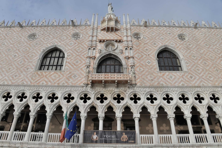 A poster of the exhibition hangs from Venice's Doge's Palace.