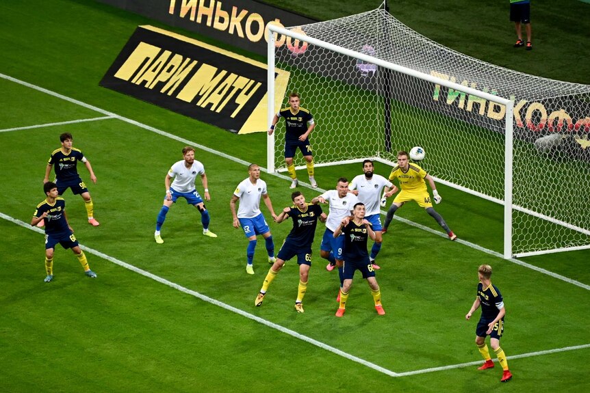 FC Soci and FC Rostov players jump for the ball near the goal during a soccer match in Sochi