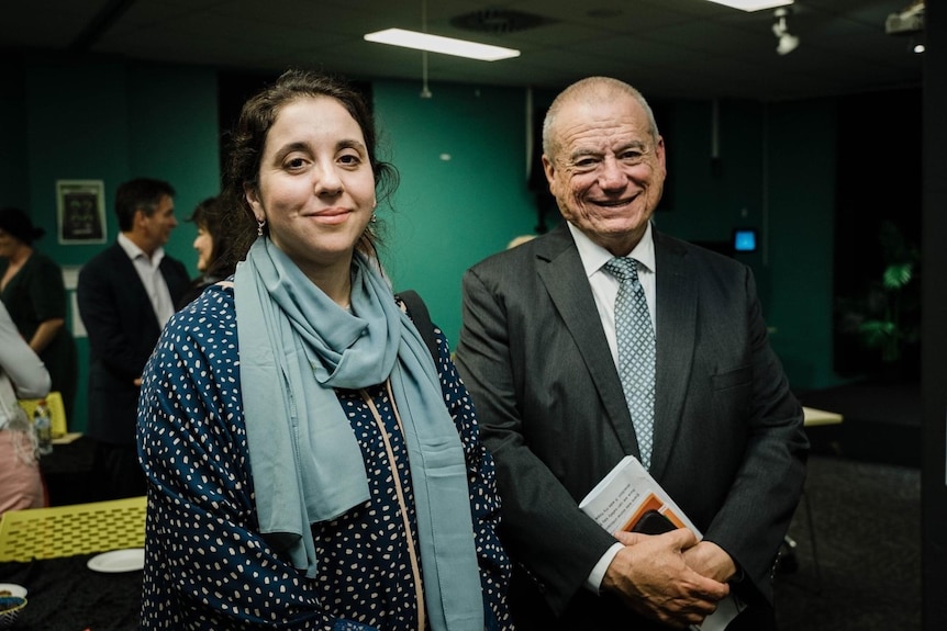 A man and a woman in professional clothing