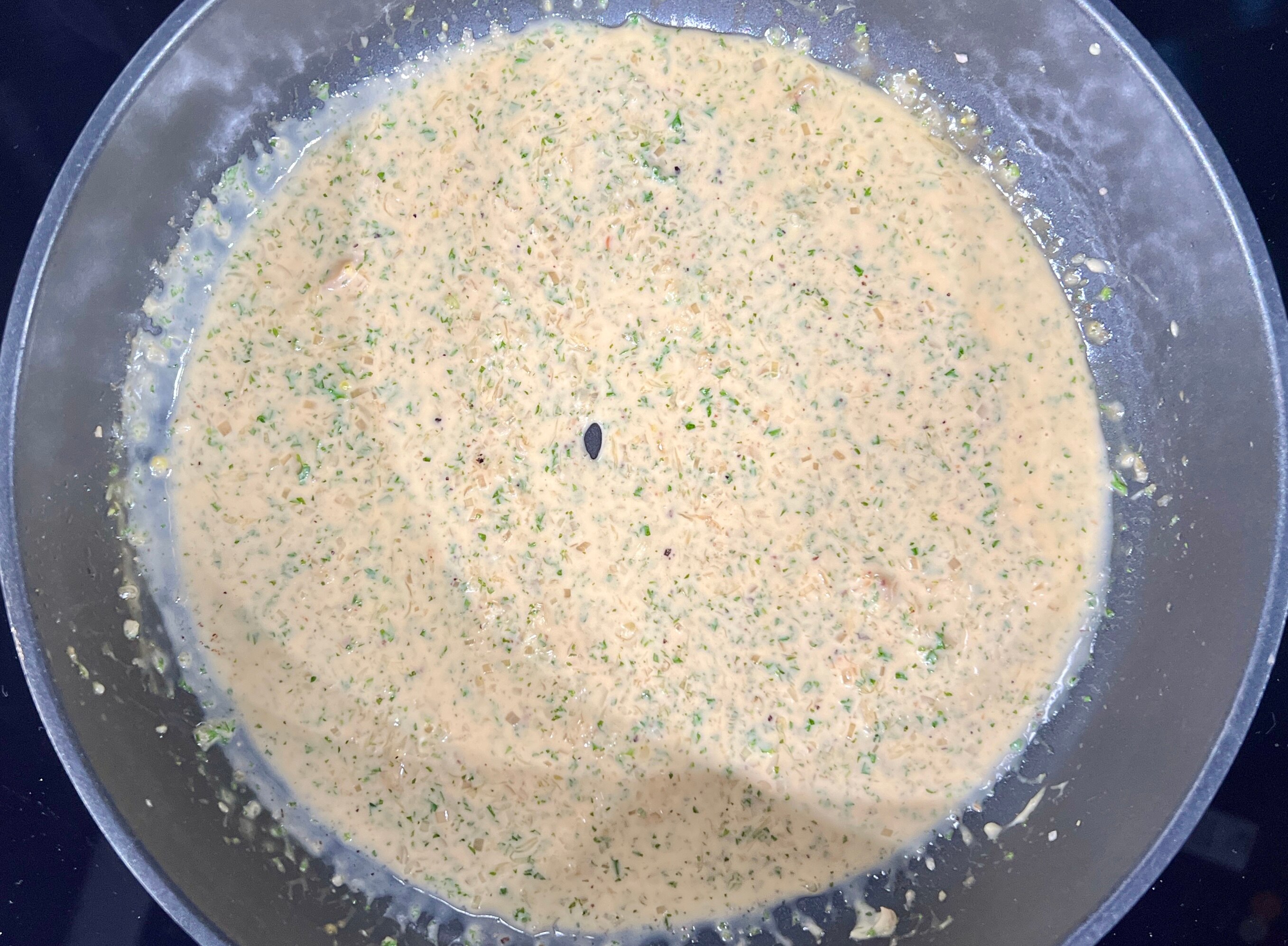 A picture of chicken juice sauce simmering in pan.