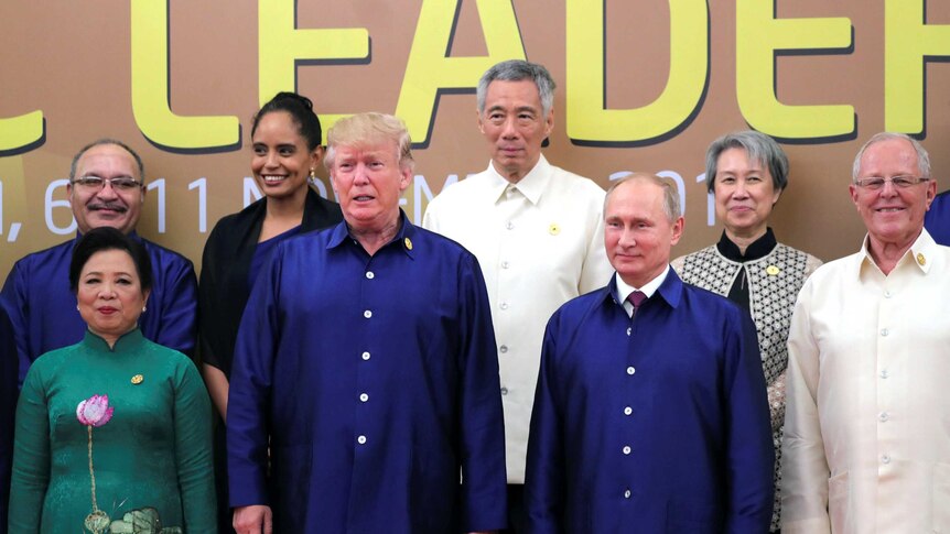 US President Donald Trump and Russian President Vladimir Putin take part in an APEC family photo.