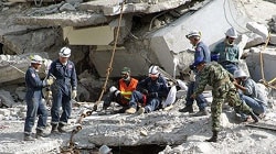 A rescue team works among the debris of Margalla Towers.