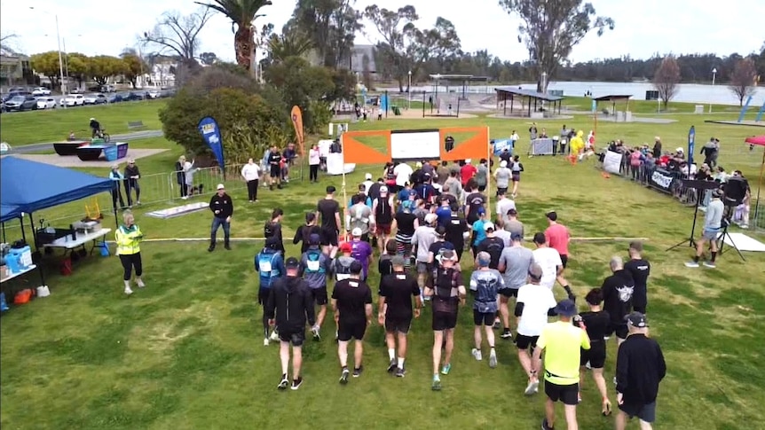 A drone shot of a group of runners at the start of a race 