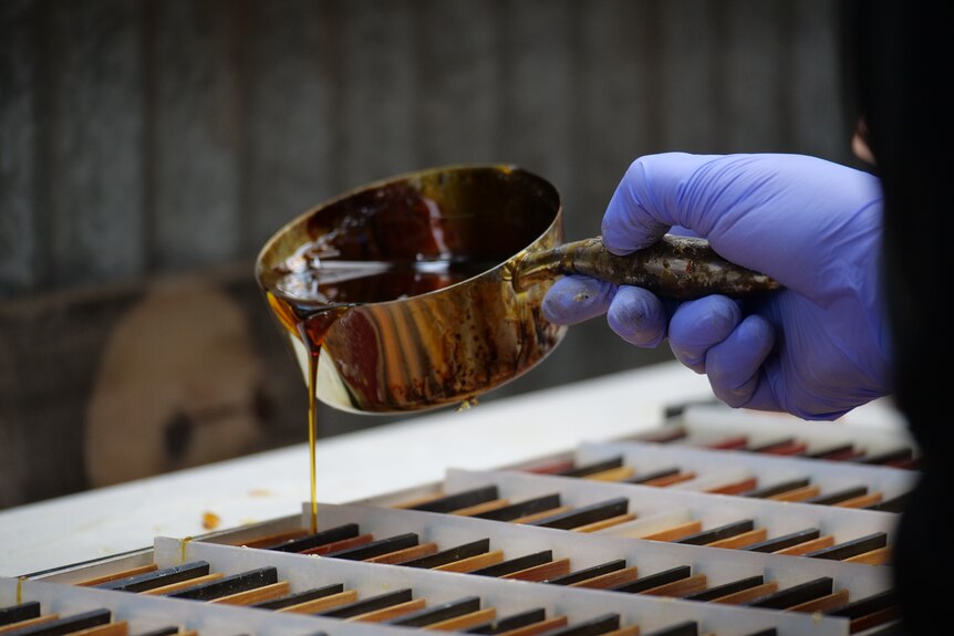 A liquid being poured into moulds.