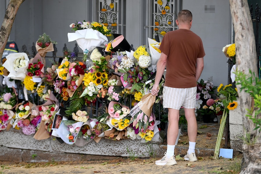 Members of the public place floral tributes at the Paddington residence of Jesse Baird in Sydney