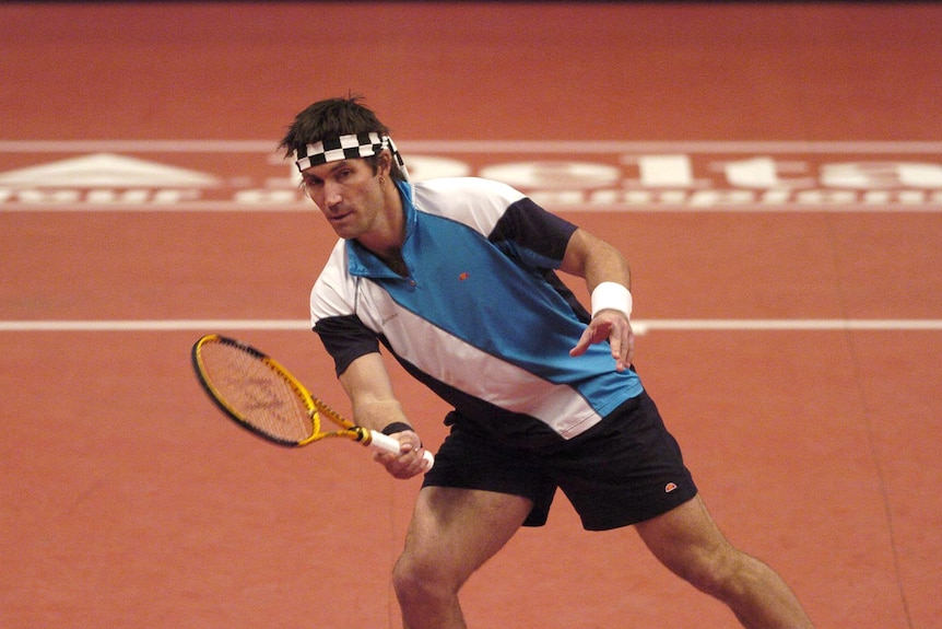 Pat Cash plays a volley at the net at the 2005 Masters tennis tournament in London