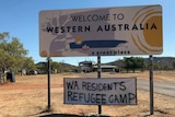 A sign on the border saying 'WA residents refugee camp'