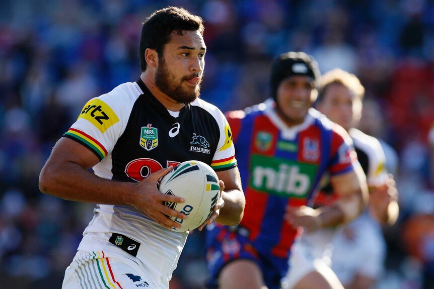 The Penrith Panthers' James Tamou runs the ball against the Newcastle Knights