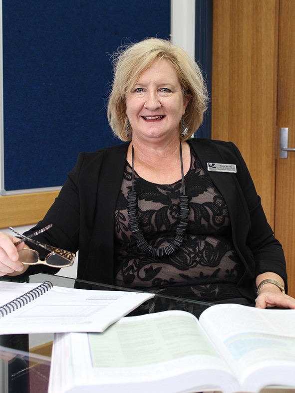 Woman at desk with books