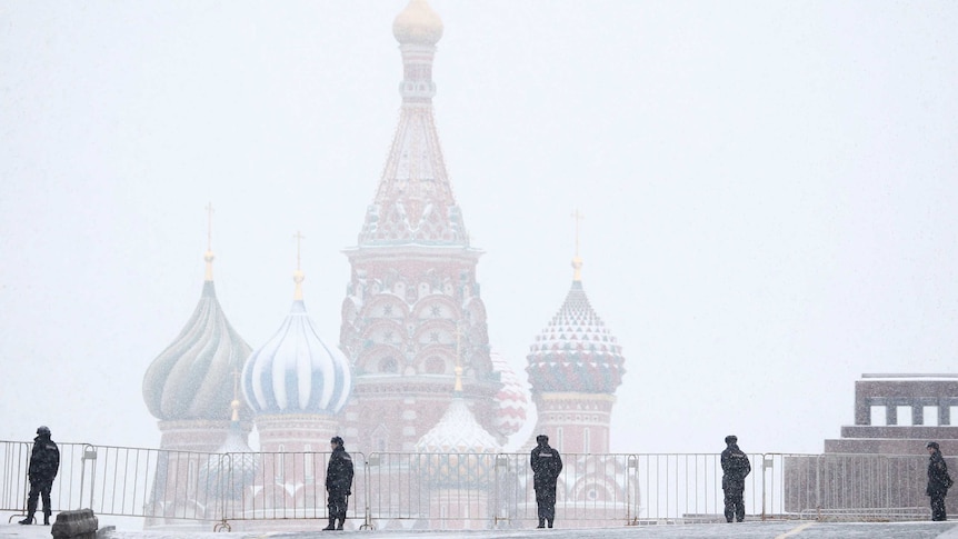 Police block access to the Red Square during a snowfall