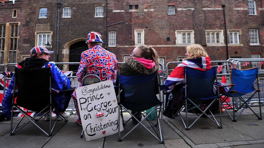 Royal supporters sit opposite St James's Palace in central London.