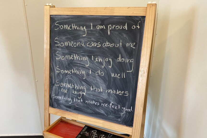 A small blackboard covered in sentences promoting positive thinking.