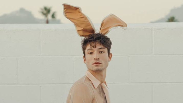 An actor in bunny ears and a white jumpsuit