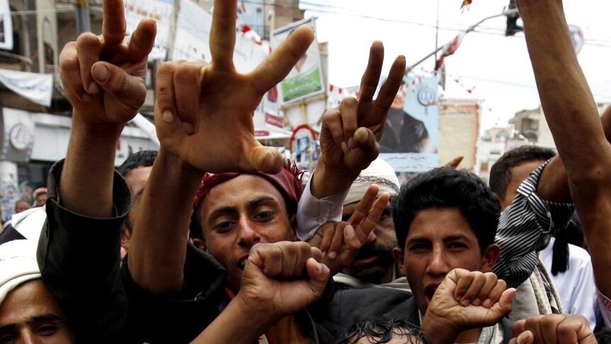Yemeni anti-government protesters shout slogans during a demonstration