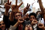 Yemeni anti-government protesters shout slogans during a demonstration