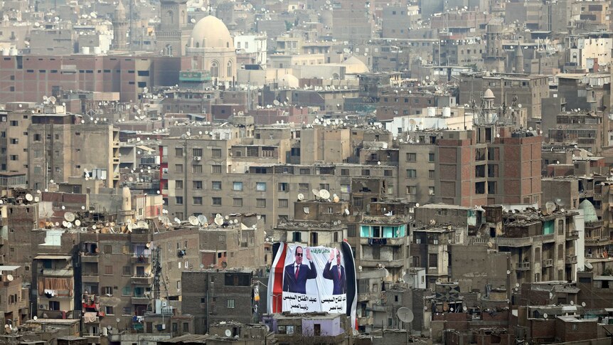 A banner supporting President Abdel Fattah al-Sisi's re-election hangs on a building.