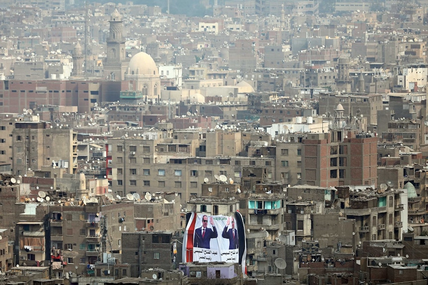 A banner supporting President Abdel Fattah al-Sisi's re-election hangs on a building.