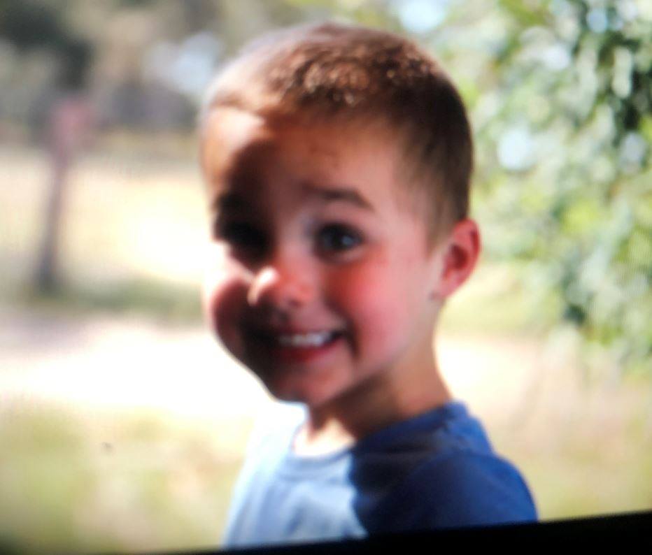 A young toddler smiling at the camera.